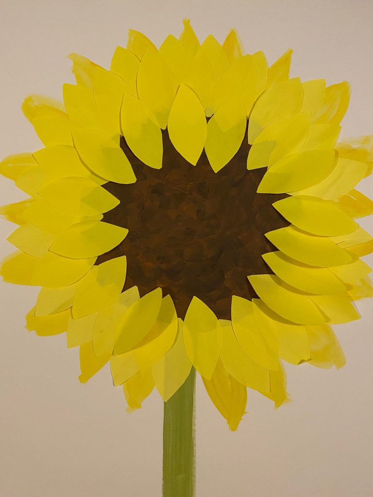 A large sunflower painted onto white card, with yellow post it note petals attached