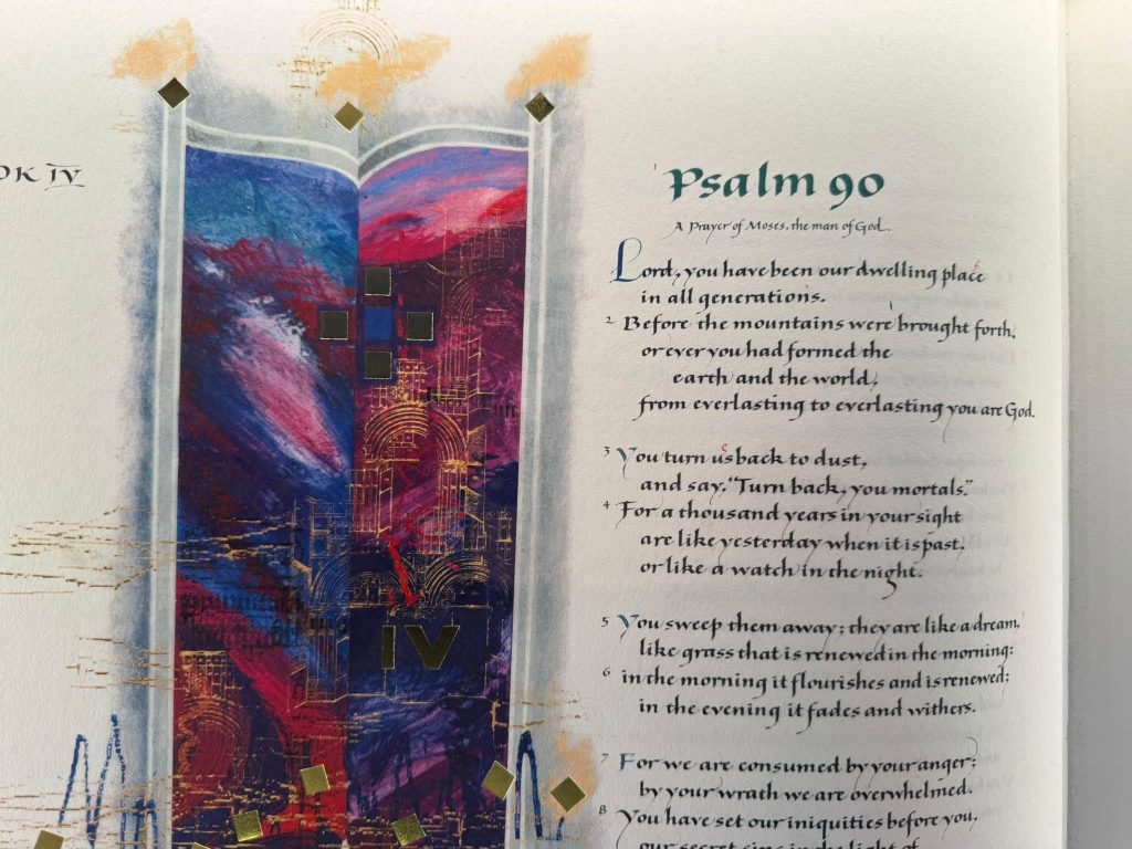 part of a page from a large bible. On the left is a purple/pink/gold patterned image. On the right in glorious calligraphy it reads Psalm 90, A prayer of Moses, the man of God, and it goes on to detail the first 7 verses of Psalm 90